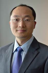 A person in a suit and tie Description automatically generated with medium confidence